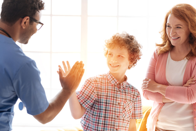 Teenager sitting with their parents during a consultation